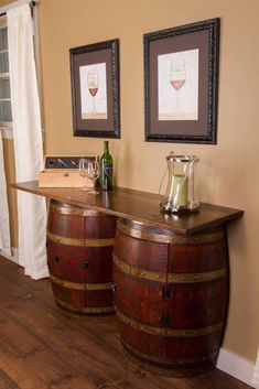 two wine barrels sitting on top of a wooden table