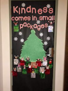 a door decorated with christmas decorations and writing that says, kindness comes in small packages