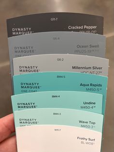 a person holding up five different colors of paint samples in their hand, with the words dynasty marquee on them