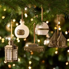 ornaments hanging from a christmas tree with lights in the background and a car ornament