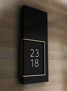 a black and gold clock mounted to the side of a wall