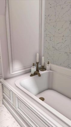 a white bathroom sink sitting under a mirror next to a bath tub with candles on it