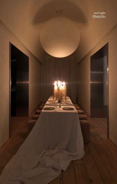 a long table with candles on it in the middle of a room