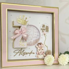 a pink and gold framed birthday card with a teddy bear, balloon and crown on it