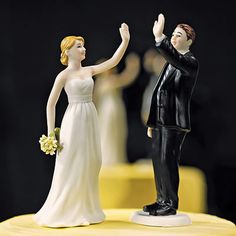 a bride and groom figurine on top of a cake