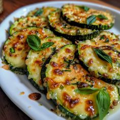 zucchini with cheese and herbs on a white plate