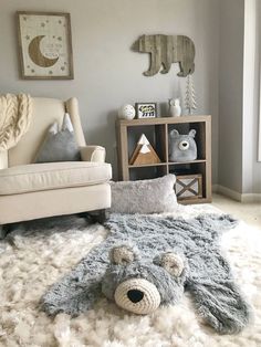 a teddy bear rug on the floor in a child's room with a chair and bookshelf