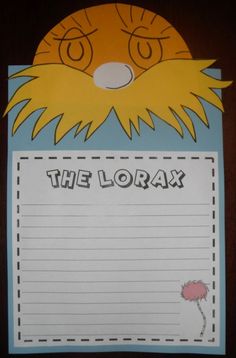 the lorax paper craft is hanging on a bulletin board with a notepad attached to it