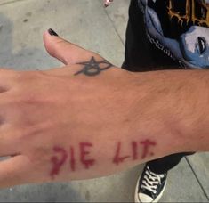 a person with a tattoo on their left hand has the word pie lit written on it