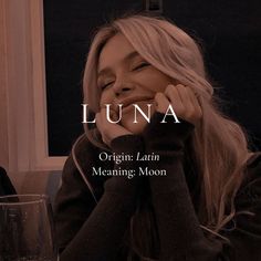 a woman sitting at a table with her hands on her face and the words luna in front of her