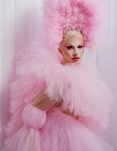 a woman in a pink dress and big hair