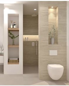 a bathroom with a toilet, sink and shelves on the wall next to each other