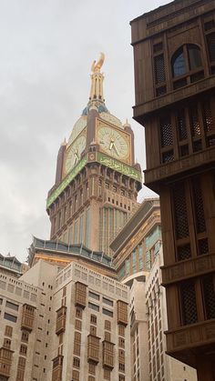 a tall building with a clock on it's face in front of a cloudy sky