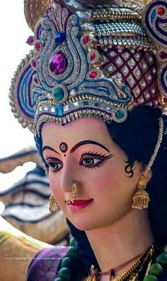 a close up of a woman wearing an elaborate headdress