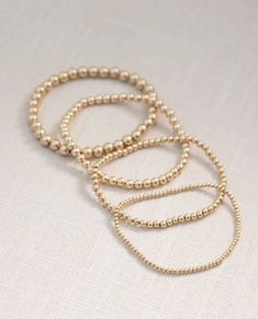 We love all things gold! Keep it simple and wear it alone or have some fun by stacking multiple bracelets together. 4mm Gold-filled causes the layers of karat gold to bond to high-quality metal to maintain superior quality One size Stretch-fit Gold Ball Bracelet, Beads To Make Bracelets, Gold Bracelets Stacked, Make Bracelets, Multiple Bracelets, Gold Bracelet Set, Ball Bracelet, Anklet Jewelry, Jewelry Case