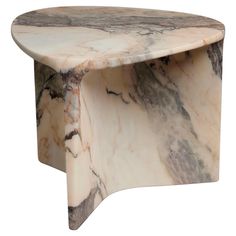 a marbled table with curved legs on an isolated white background for use as a coffee table