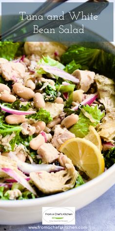 tuna and white bean salad in a bowl with lemon wedges on the side, ready to be eaten