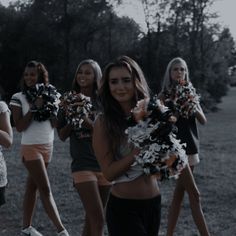 a group of young women holding cheerleader's pom poms