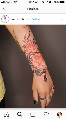 a woman's hand with a rose tattoo on it and an arrow in the middle