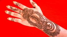 a woman's hand with henna tattoos on it