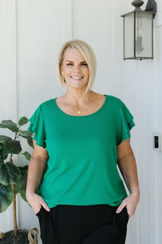 Experience the joy of wearing the Sophia Top! This emerald green solid shirt features ribbing for added texture, a round neck for comfort, and short flutter sleeves for a touch of playfulness. Perfect for everyday wear or dressing up for a night out. Model is wearing a large and is 5'5". Plus model is wearing a 1X and is 5'7". Size Chart Length Bust S 22.5" 32" M 23.5" 34" L 23.5" 36" 1x 26.5" 43" 2x 27" 46" 3x 27" 50" *All measurements are approximate and done while hanging.* Fabric and Care 92% Polyester 8% Spandex Hand wash cold separately, only non-chlorine bleach when needed, flat dry, warm iron if needed. Green Crew Neck Top For Day Out, Green Ribbed Trendy T-shirt, Green Casual Flutter Sleeve Top, Casual Green Top With Flutter Sleeves, Solid Casual T-shirt With Flutter Sleeves, Green Ribbed Short Sleeve Tops, Trendy Green Flutter Sleeve Tops, Green Flutter Sleeve Blouse For Day Out, Chic Green Tops With Ruffle Sleeves