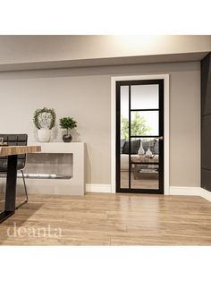 an empty room with a table and chairs in front of a glass door that leads to a living area