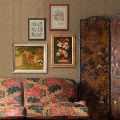 a living room filled with furniture and pictures on the wall