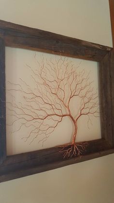 a framed tree is shown with roots in the center and on the wall above it