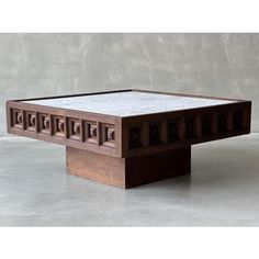 a coffee table made out of wood and white marble inlays on the top