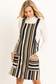 a woman wearing a striped dress with pockets