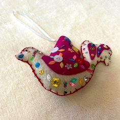 an ornament shaped like a bird on a white background