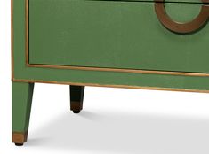 a green dresser with two drawers and an oval handle