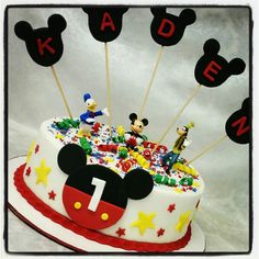 a birthday cake with mickey mouse decorations on top