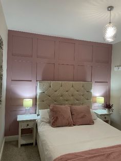 a bedroom with pink walls and white bedding