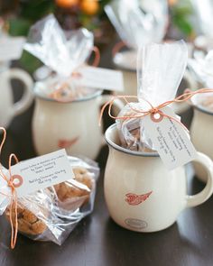 coffee cups filled with cookies sitting on top of a table