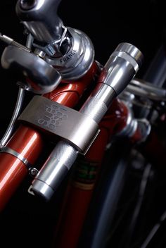 a close up view of the handlebars on a red and silver bike with a black background