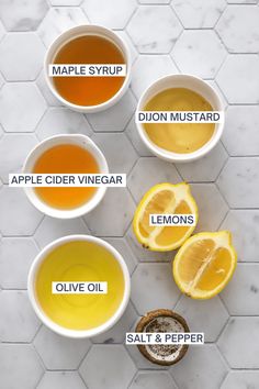 the ingredients for apple cider vinegar, lemons and maple syrup on a marble background