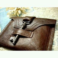 a brown leather wallet with a key on it