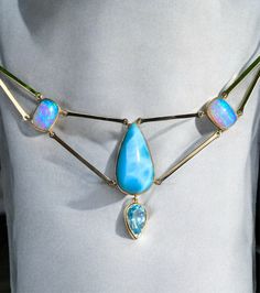 Blue Australian Opal Lemurian High Priestess Necklace with High Grade Larimar- solid 14k yellow gold. Larimar is 26mm in length by 14mm. The two Australian opals are each 11mm by 8mm. Top of larimar to bottom of aquamarine is 32mm in length. I made this High Lemurian Priestess Opal Necklace months ago and couldn’t part with it at the time. It features a stunning high-grade Larimar paired with a dangling aquamarine pearl and two incredible, large, sparkling Australian blue opals, a rare bright li Alchemy Jewelry, Rare Colors, High Priestess, Tourmaline Necklace, Metal Bar, Australian Opal, Green Tourmaline, Opal Necklace, Gemstone Healing