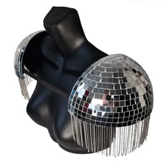 a black mannequin head with silver disco balls on it