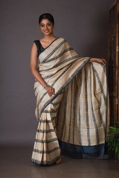 This saree is popular for its colors. The use of black and white is so subtle that it attracts any saree lovers. This unique monochrome creates a certain aura around this tussar saree. Though it has only two colors, it adds a splash of colors to your life. This handwoven gachi tussar silk saree is already a showstopper. Many of our customers are choosing this over other sarees. The horizontal pattern over the body makes it look beautiful. The patterns complement the body of these traditional tus White Saree With Block Print In Traditional Drape, White Tussar Silk Saree With Block Print, White Saree With Block Print, White Chanderi Blouse Piece With Block Print, Bhujodi Saree, Black And White Saree, Ladylike Dress, Tussar Saree, Blue Silk Saree