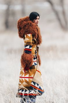 Most Orders Ship within 1-2 Business Days Full length unlined duster with a fur-lined hood, fur cuffs, lined raglan sleeves, waist tie belt with loops and lined patch pockets Celeste is 5'10" and wears size OS. Body of duster is made from Pendleton's Medicine Bow Blanket. Napped Pendleton blankets: 82% Wool, 18% Cotton. Wool Cashmere facings and Silk Rayon peachskin lining. Leather Brown Mongolian Fur is a shaggy long hair Mongolian sheep shearling. Native American tribes traveled to Wyoming’s M Bow Blanket, Pendleton Blankets, Western Womens Fashion, Shaggy Long Hair, Pendleton Blanket, Mongolian Fur, Fur Cuffs, She's A Lady, Hooded Cloak