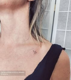 a woman with a small bird tattoo on her chest