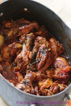 a pot filled with meat and vegetables on top of a table