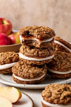 a stack of oatmeal cookies sitting on top of each other next to an apple