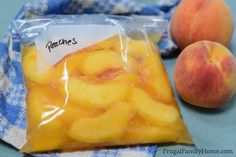 two peaches are sitting next to each other on a blue and white cloth with a bag of peaches