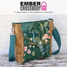 the messenger bag is decorated with flowers and birds