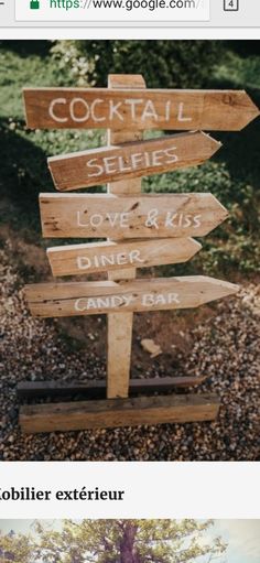 a wooden sign sitting on the side of a road