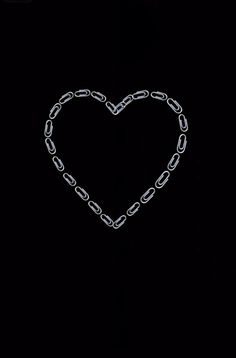 a heart made out of chains on a black background