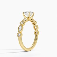 a yellow gold ring with diamonds on it